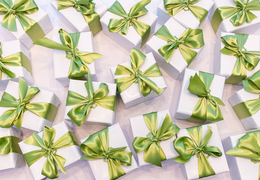 wrapped gifts with green bow - Corporate Gift Ideas